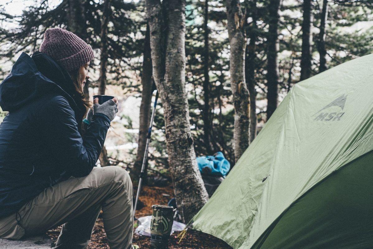 Lady camping in woods