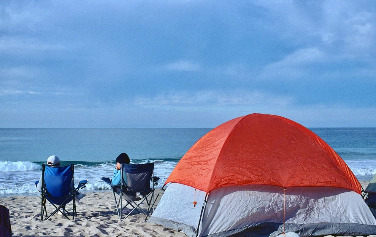 people camping at a beach