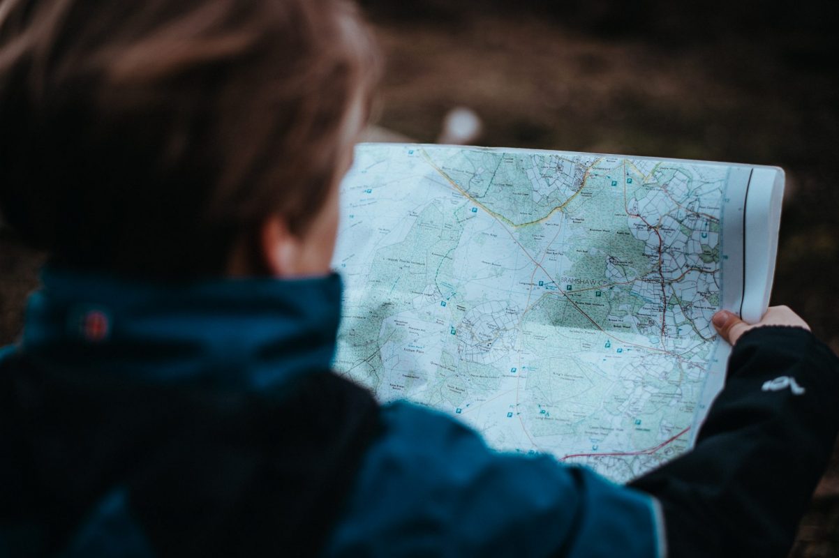 hiking woman holding a map in her hands