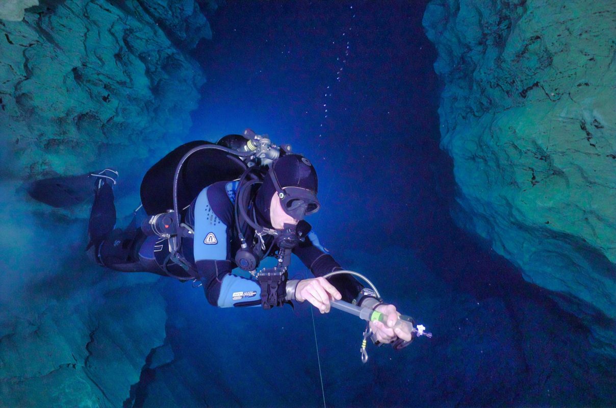 person cave diving