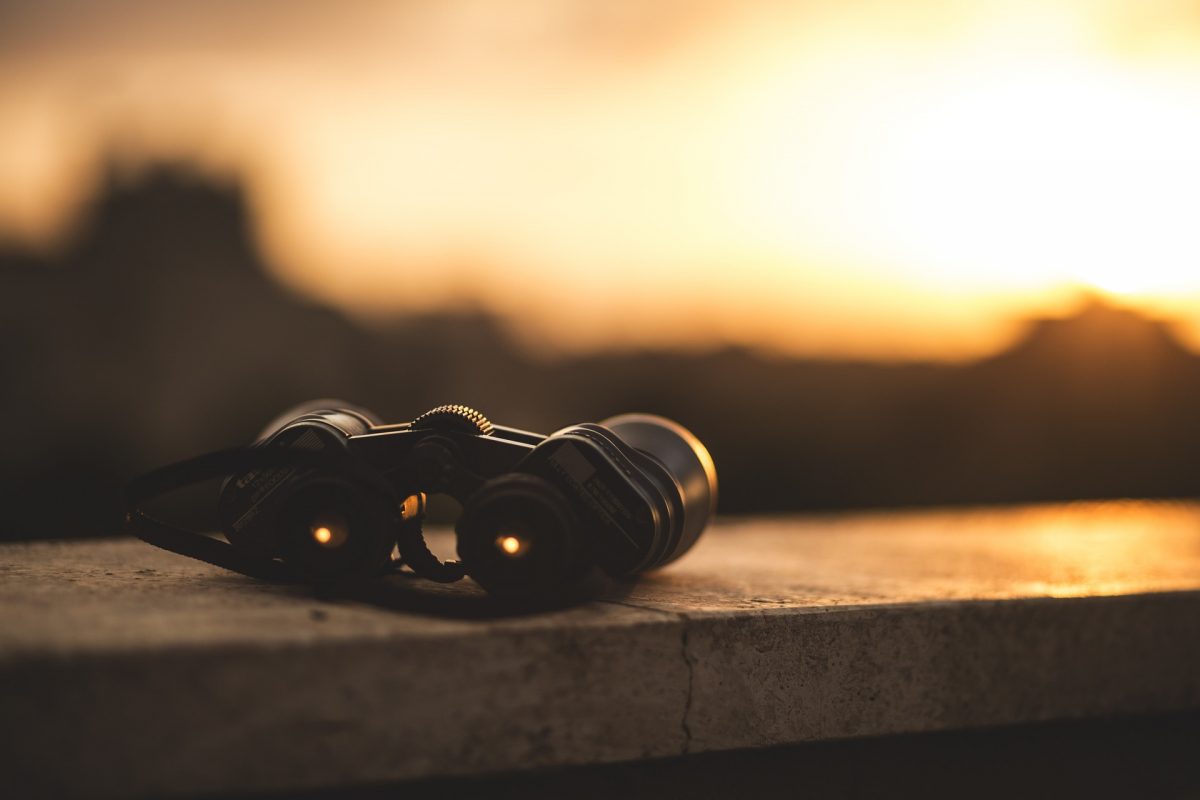 binoculars on a wall in the sunset
