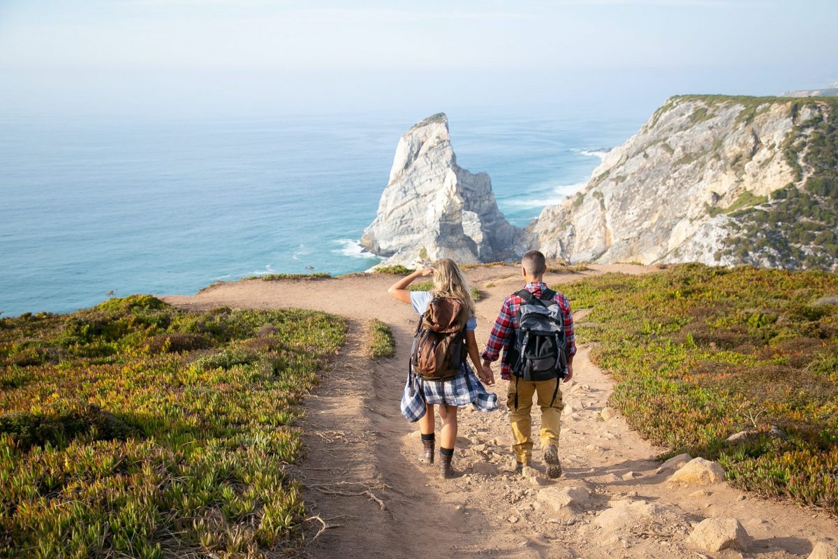 couple hiking on coastal trail